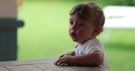 Baby toddler holding on table furniture