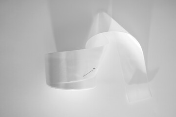 Roll of white textile ribbon. Mockup of roll from satin fabric tape on white background