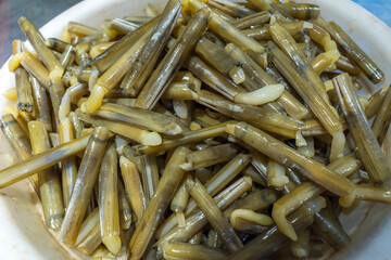 Beihai, China - July 18, 2019: Fresh clams from the sea at a local wet market in downtown Beihai.