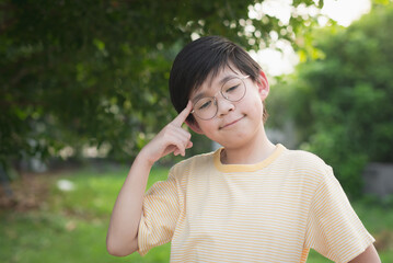 Portrait of unhappy asian child wearing glasses