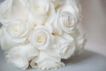 Obraz na płótnie Canvas Wedding bouquet of white roses on a white background with soft focus and copy space.