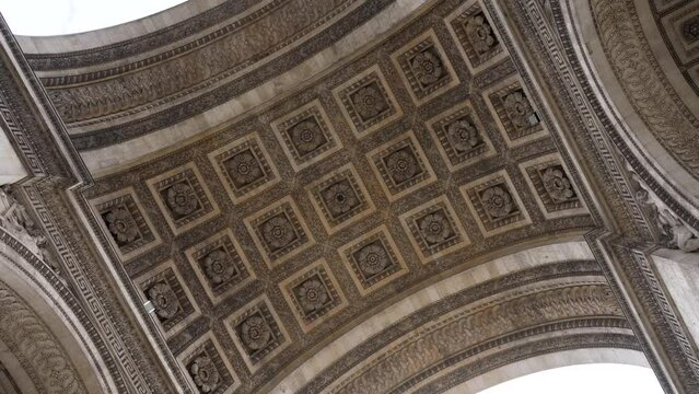 Low-angle view under vault of Triumphal Arch. Close-up of ornate ceiling of Triumphal Arch in Paris. One of most famous monuments in France, no people. Concept of vacations in France.