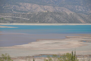 big river with huge mountains in the background in broad daylight