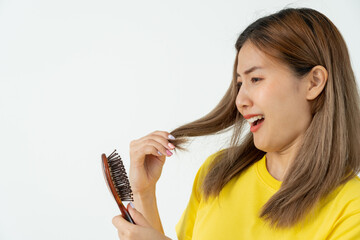 Asian woman very sad and upset looking at damaged hair, hair loss, hair thinning problem, vitamin...