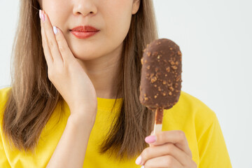 Asian woman feel sensitive teeth after eating ice cream, female suffer tooth, decay problems,...