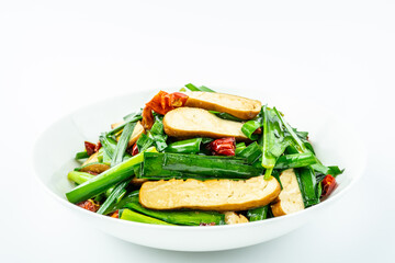 Fried fragrant dried chives on a plate on a white background