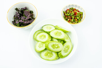 Chopped perilla and cucumber ingredients on white background