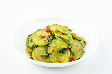 Fried cucumbers with perilla on a plate on a white background