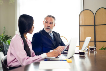 Obraz premium woman secretary. Smiling Asian female secretary gives CEO senior business owner paper documents