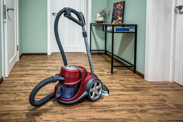 Professional vacuum cleaner on ceramic tiles floor in corridor