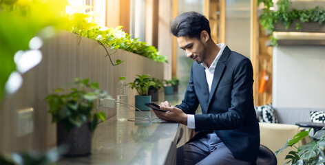 Happy asian young man using mobile phone for social media applocation, online app for communication. Urban business handsome male
