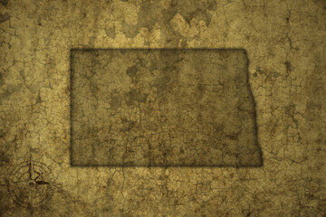 map of north dakota state on a old vintage crack paper background .