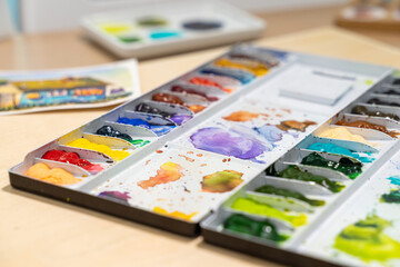 Colorful of watercolor tray background with watercolor set. Selective focus.