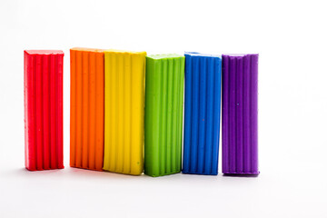 multicolored plasticine highlighted on a white background, hobbies and education