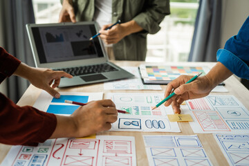 Group of asian creative team programing designers participate in all phases of the UX design.