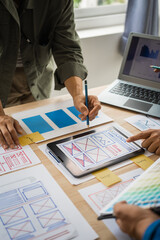 Group of asian creative team programing designers participate in all phases of the UX design.
