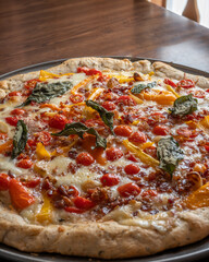 a freshly homemade pizza with fresh vegiitables