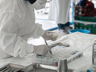 scientist working in the laboratory, note shallow depth of field  focus on the pipette