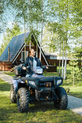 A woman who lives in country house uses ATV to navigate rough terrain