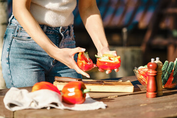 Closeup view of cutting fresh bell pepper for barbecue