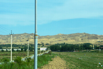 People on an agricultural field among the mountains