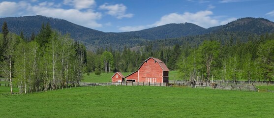 Panorama of a red barn in north Idaho.