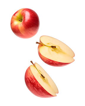 Isolated flying apple wedges. Falling pieces of red apple fruit isolated on transparent background