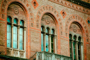 Fototapeta na wymiar the facade of the windows of the old building, ancient architecture, arched windows. High quality photo