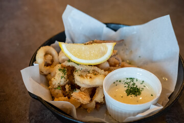 Close up of Calamari, Fried Squid served on plate with lemon