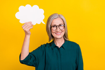 Portrait of positive friendly person hand hold empty space cloud shape card isolated on yellow color background