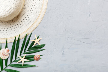 Summer holidays. Summer concept with straw hat and tropical leaf. Flat lay, top view, copy space
