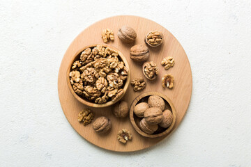 Fresh healthy walnuts in bowl on colored table background. Top view Healthy eating bertholletia concept. Super foods