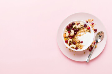 Healthy breakfast food with granola, yogurt, fruits and nuts. Dessert parfait with dried fruits for breakfast