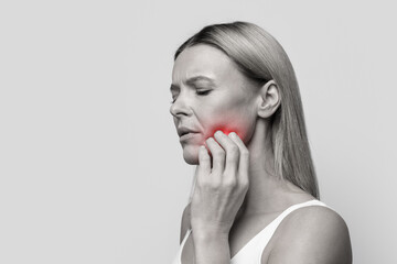 Unhappy woman suffering from strong tooth pain, copy space - obrazy, fototapety, plakaty