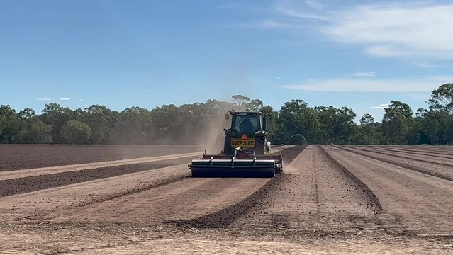 Australian farmer plowing a field with tractor in Queensland. According to Australian Bureau of Statistics there is 369 million hectares of agriculture land in Australia