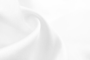 A twisted piece of white fabric. White material or texture with waves and folds. Wrinkled white...