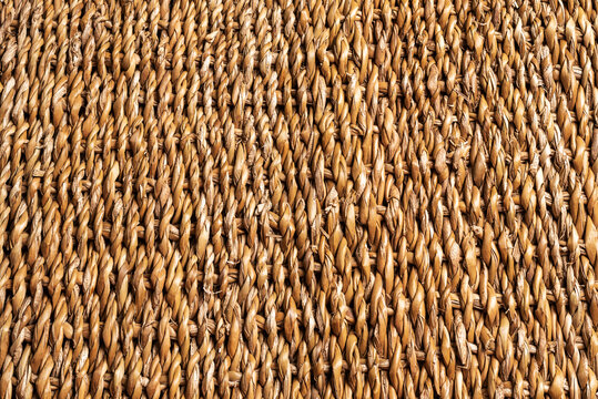 Background or texture of braided cattail, brown color, copy space.