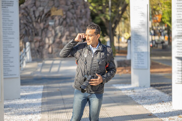 Young latin man talking on mobile phone with copy space.