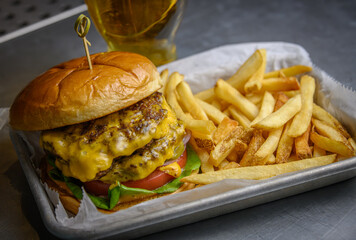Double Cheeseburger Plate with French Fries and a Draft Beer