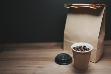 Paper bag and paper cup with coffee beans. image of delivery