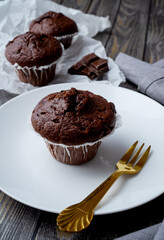 Chocolate muffin on a white plate
