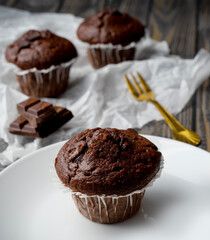 Chocolate muffin on a white plate