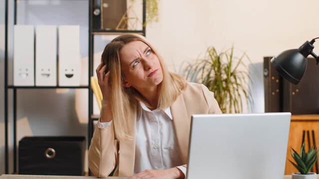 I dont know what to say. Confused business woman working on laptop at office workplace. Freelancer feeling embarrassed about ambiguous question, having doubts, no answer idea, being clueless uncertain