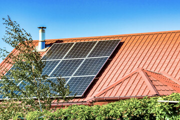Solar panels on the roof of a country house, environmental production of solar energy in electrical.