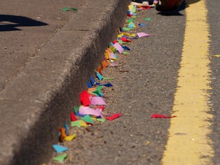 Confetti at street carnival celebration blowing in the wind 