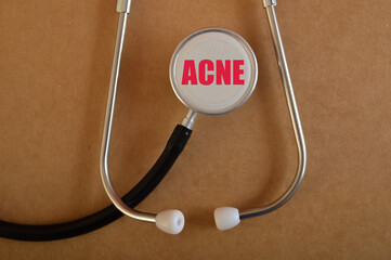 Stethoscope with text ACNE. Acne is a common skin condition that occurs when hair follicles become...
