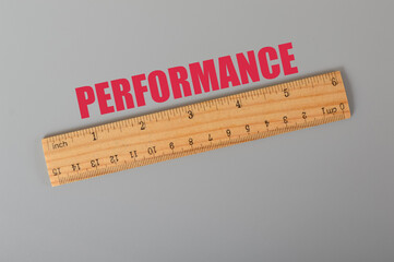 Wooden ruler with text PERFORMANCE. Performance concept.