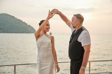 couple dancing on luxury yacht at the sea