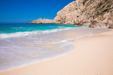 Obraz premium Petani Beach with white sand and azure water against blue sky - Kefalonia island, Ionian sea, Greece.