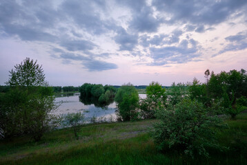 Fototapeta na wymiar Evening sky over flooded fields in spring